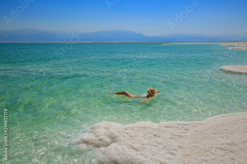 Girl relaxing in the water of Dead Sea photo