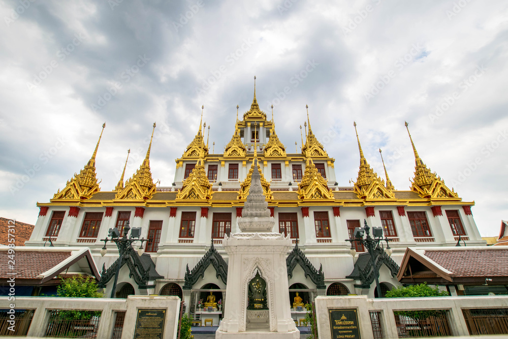Fototapeta premium Loha Prasat , The metallic castle covered with gold leaf at of Wat Ratchanadda Temple in Bangkok, Thailand.