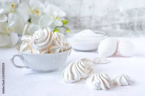 Meringues.  Protein sugar cake for tea or coffee. Light background.White morning. Candy