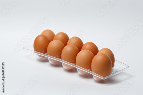 brown eggs in basket isolated on white background