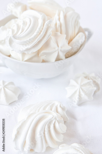 Meringues. Protein sugar cake for tea or coffee. Light background.White on white.