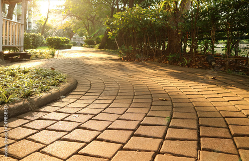 Garden's curving stone block pathway in the gentle sunlight