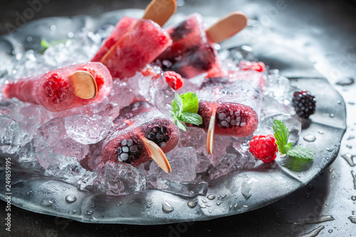 Delicious berry fruits ice cream on a stick