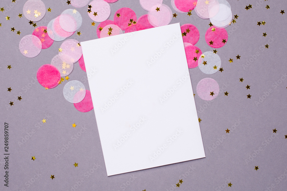 Present card and pink confetti with gold stars on gray background