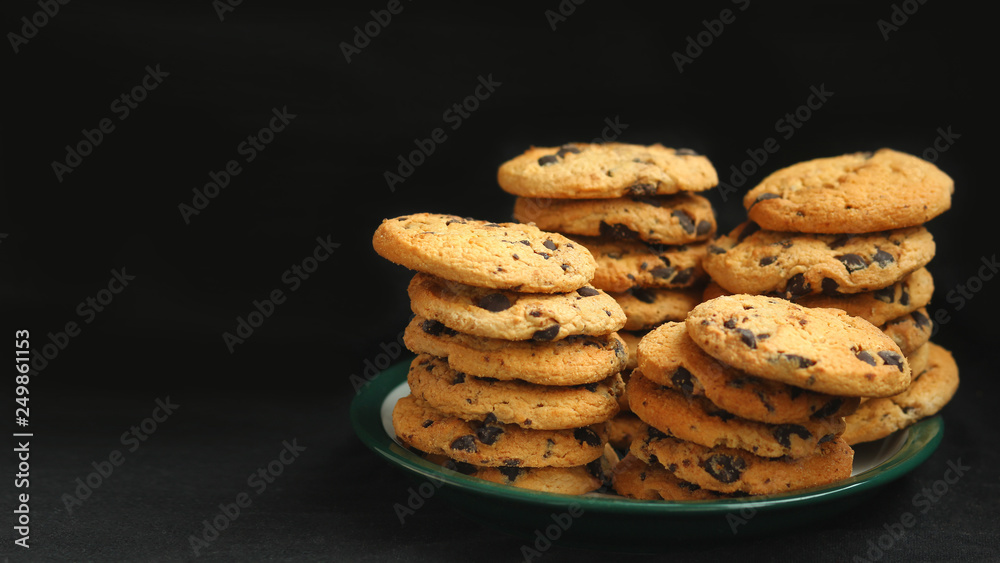 Closeup of homemade Chocolate Chip Drop Biscuits / Cookies isolated on black with negative space