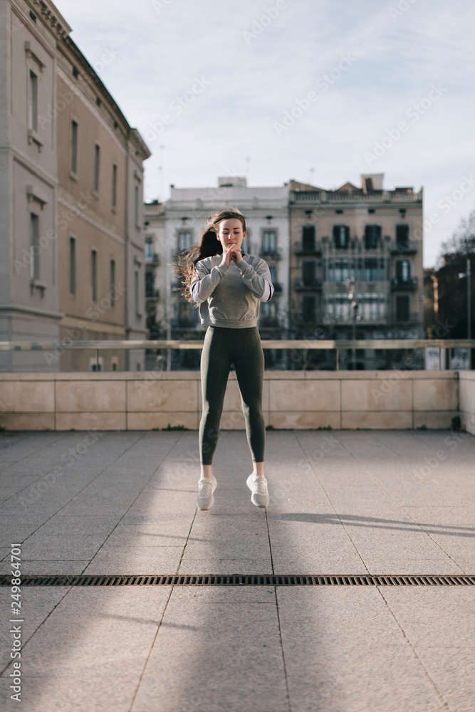 young woman doing workout in the city