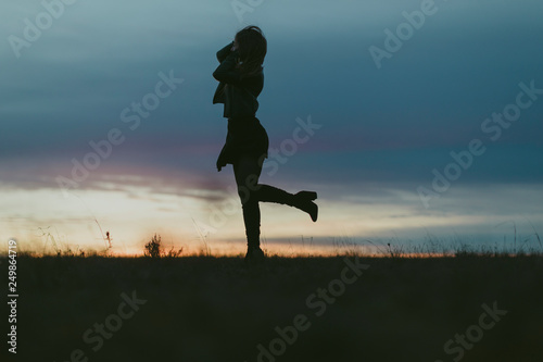 silhouette of woman at dusk.