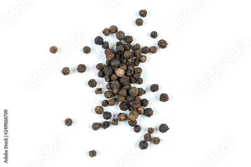 heap of black pepper peppercorns isolated on white background