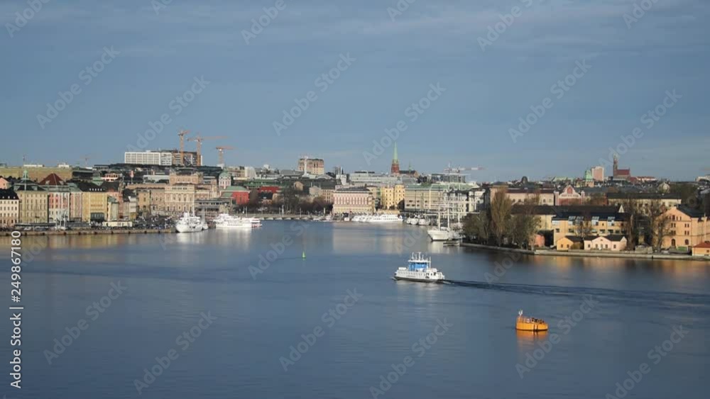 An sunny early spring day in Stockholm, view over a pier with boats, ferry and birds An sunny early spring day in Stockholm, view over a pier with boats, ferry and birds