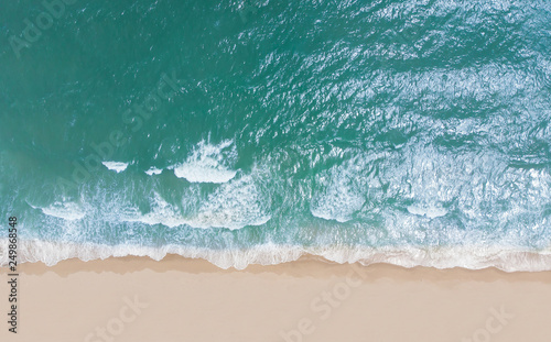 Top view of beautiful sand beach with turquoise sea water,Wave propagation,aerial view from drone camera / Summer concept.