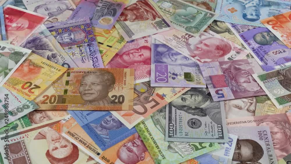 Variety of world currencies notes slow rotating. World money, economy. Low angle. 4K stock video footage Variety of world currencies notes slow rotating. World money, economy. Low angle. 4K stock video footage