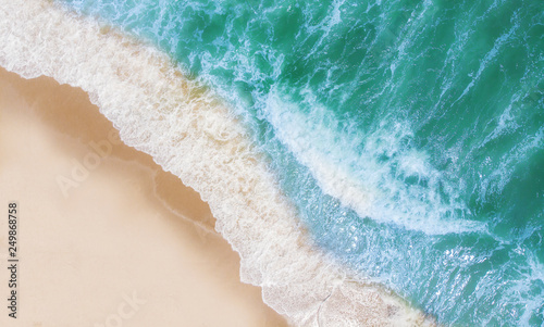 Top view of beautiful sand beach with turquoise sea water Wave propagation aerial view from drone camera   Summer concept.