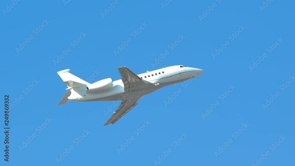 Generic Unmarked Executive Jet Close-up Flying Up into a Clear Blue Sky on a Sunny Day Generic Unmarked Executive Jet Close-up Flying Up into a Clear Blue Sky on a Sunny Day