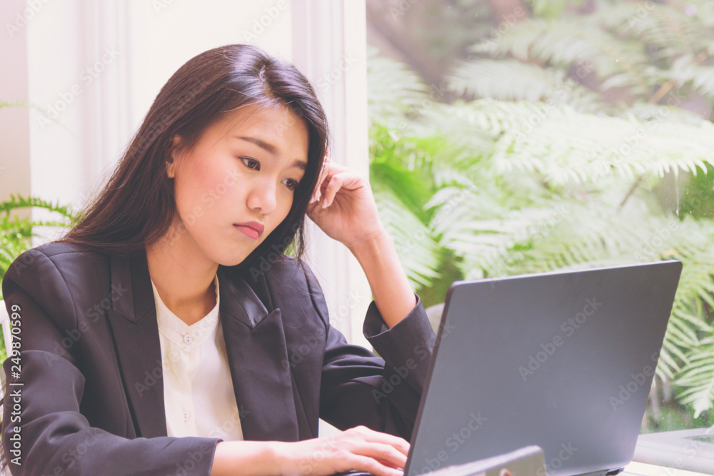 Business woman working with laptop ,Hands on the head Thoughtful expression for Thinking Planning about solution Business woman working with laptop ,Hands on the head Thoughtful expression for Thinking Planning about solution
