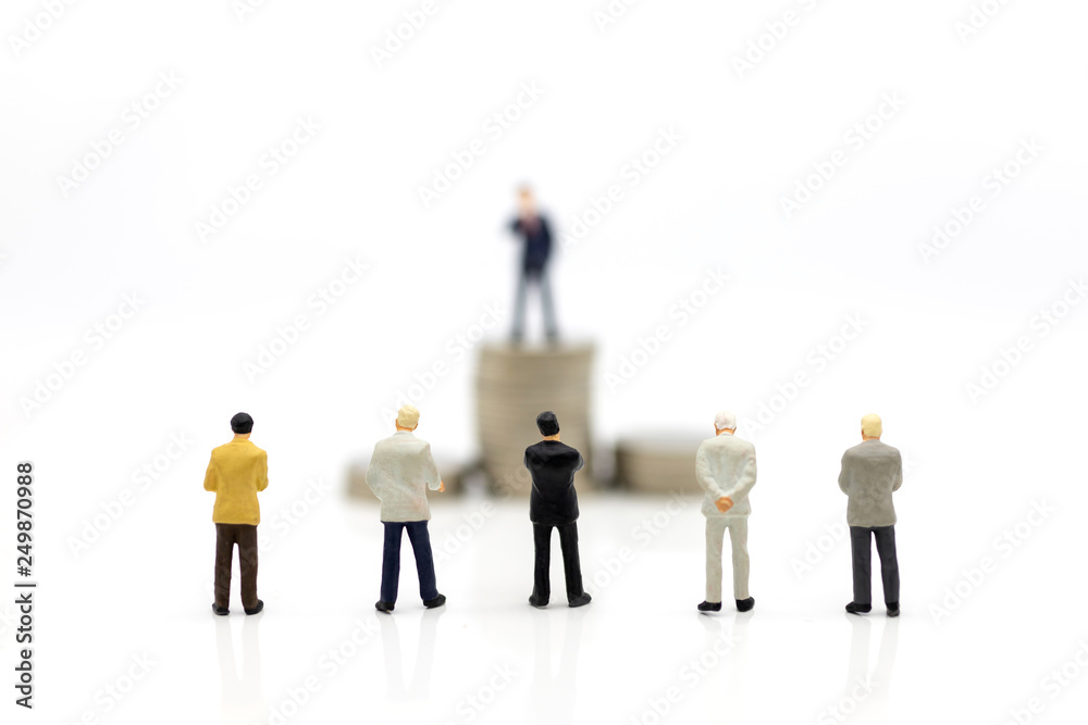Miniature people : Businessman standing front of stack of coin. Image use for financial, business vision concept. Miniature people : Businessman standing front of stack of coin. Image use for financial, business vision concept.