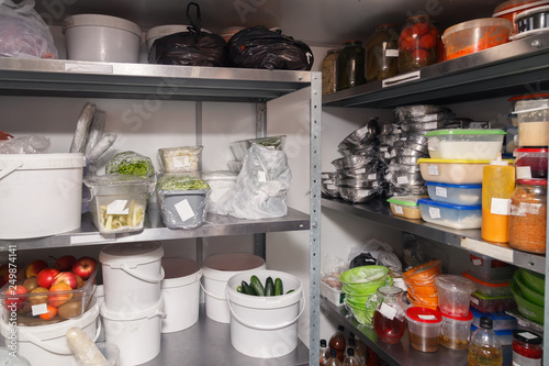 Different foods, fruits and vegetables, greens, pre-cooked dishes on plates in restaurant's warehouse. Concept banquet, catering, preparation, celebration, opening cafe