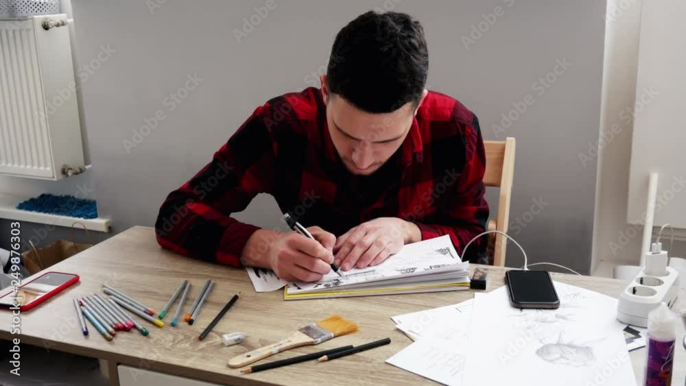Young man draws a sketch in the office Young man draws a sketch in the office