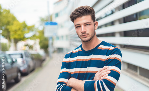 Photos Half length portrait of a beautiful young man in the city