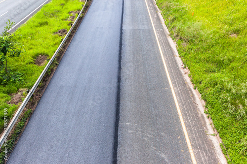 Wallpaper Mural New road  asphalt surfacing on half of highway tarred close-up overhead of travel route improvements. Torontodigital.ca