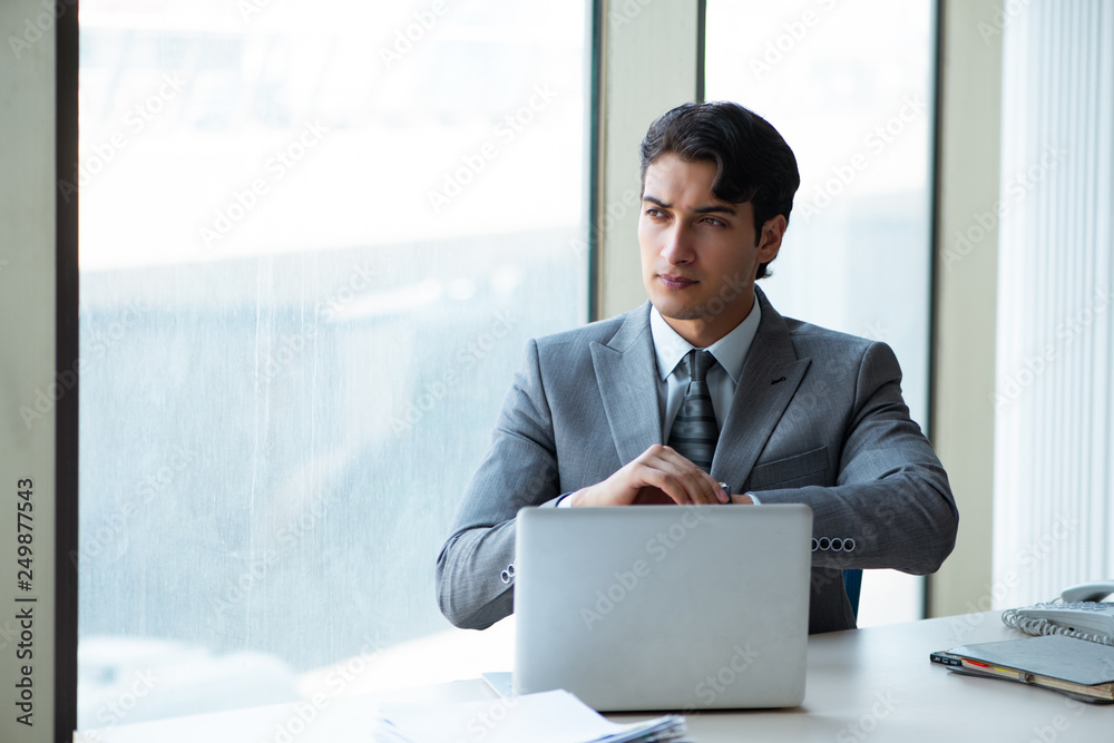 Young successful businessman working at the office Young successful businessman working at the office
