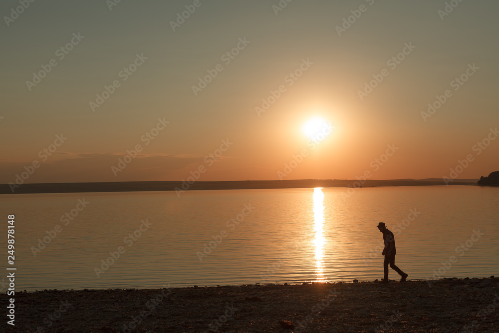 Wandering man on tranquil seashore