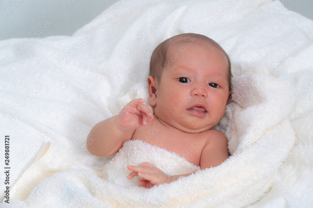 Sweet baby in a white towel after bath. Healthcare, pediatrics. Sweet baby in a white towel after bath. Healthcare, pediatrics.
