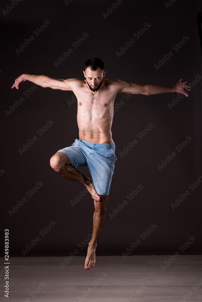 A topless man dancer performing a dancing moves A topless man dancer performing a dancing moves