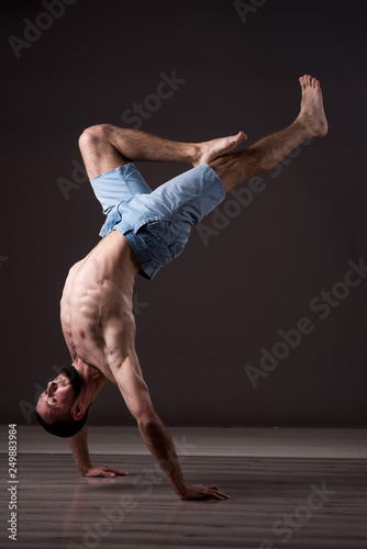 A topless man dancer performing a dancing moves
