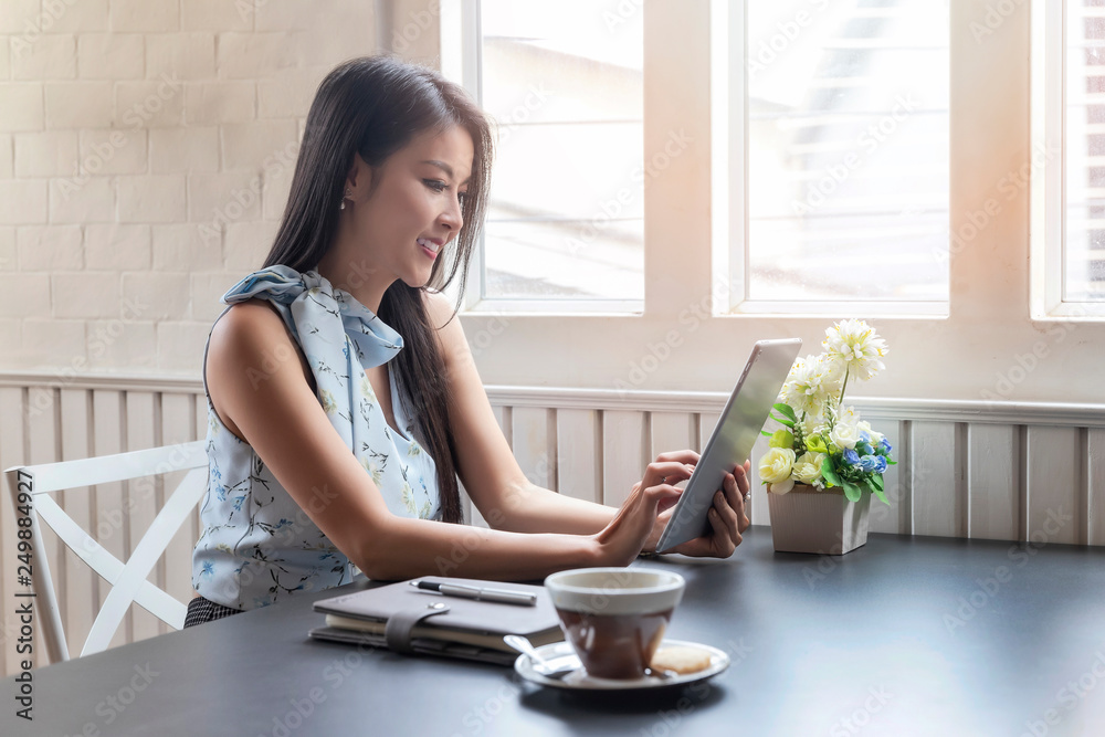 businesswoman working with tablet computer at office desk.