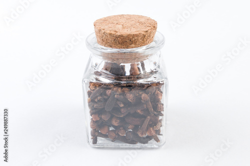 cloves in a glass jar isolated on white background