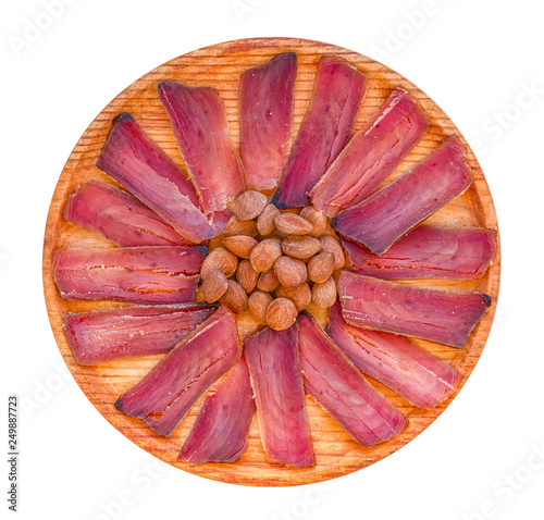 Mojama (tuna stew) dish with almonds. Typical appetizer of the east and south of Spain. White isolated.