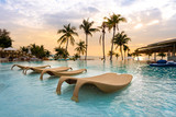 luxury swimming pool on sea view and chair in hotel resort with sunrise time
