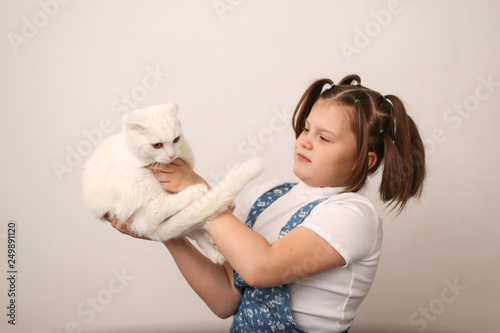 Girl child offends a cat, animal abuse