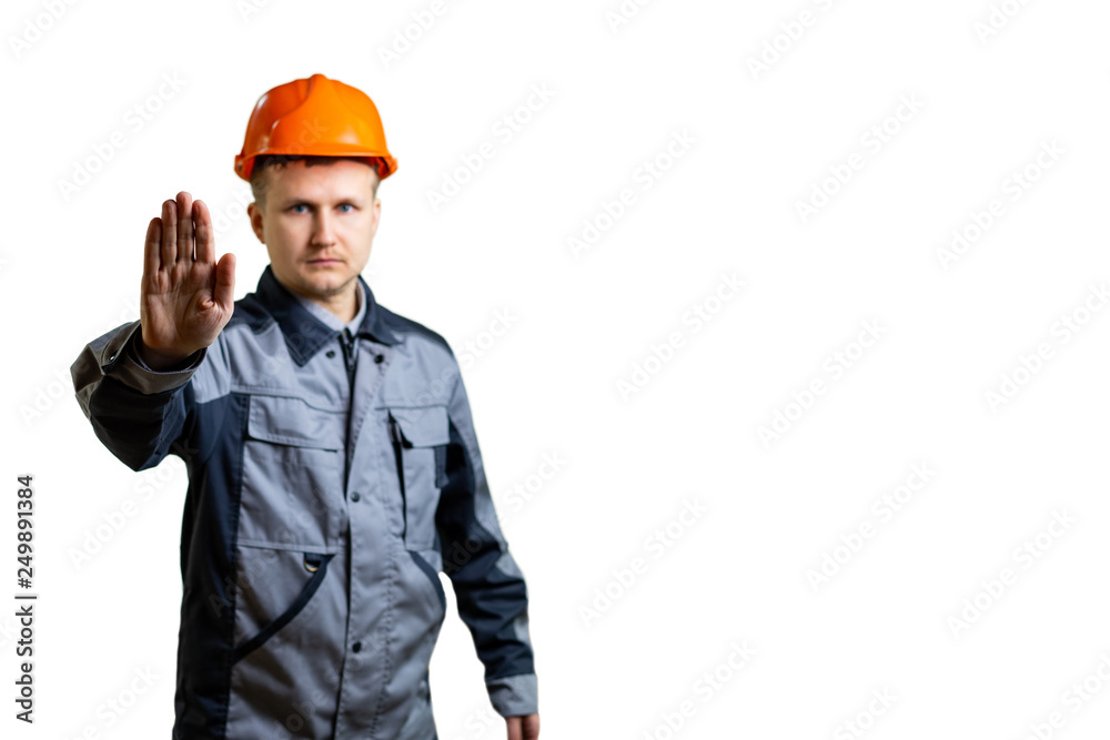 Engineer builder shows a prohibitory gesture. Focus on hand builder. Blur. isolated Engineer builder shows a prohibitory gesture. Focus on hand builder. Blur. isolated