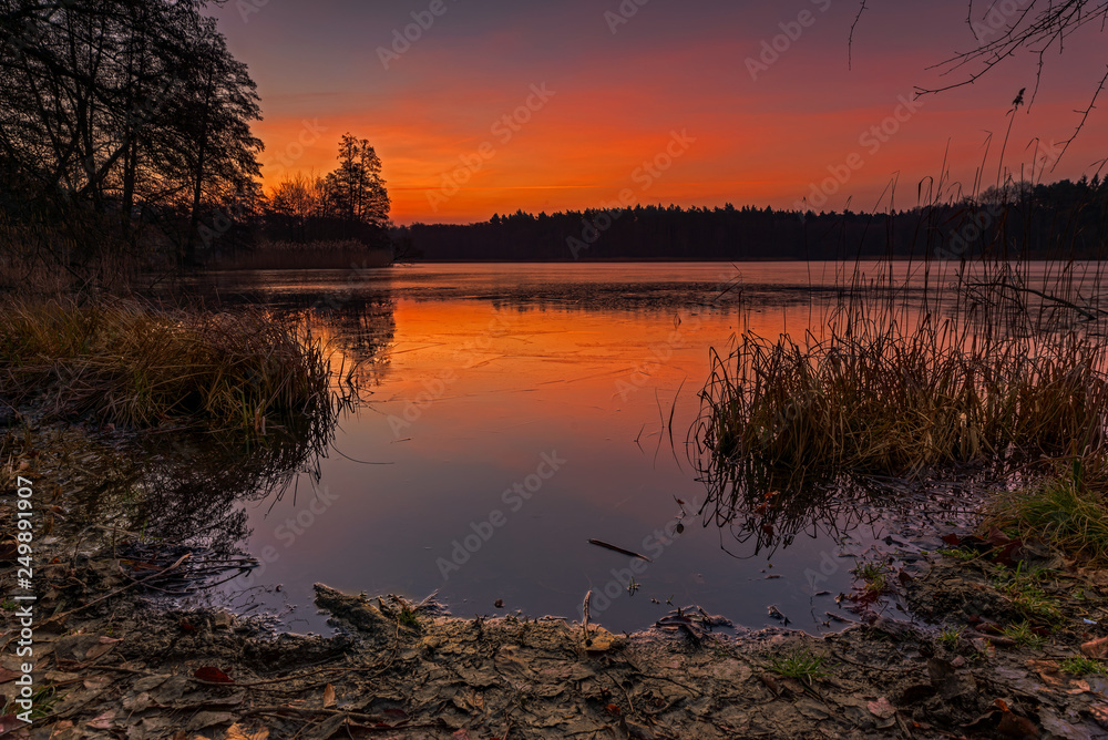 A mellow sunrise, with warm colors on a lake. Concept: postcards, calendars or travel and recreation
