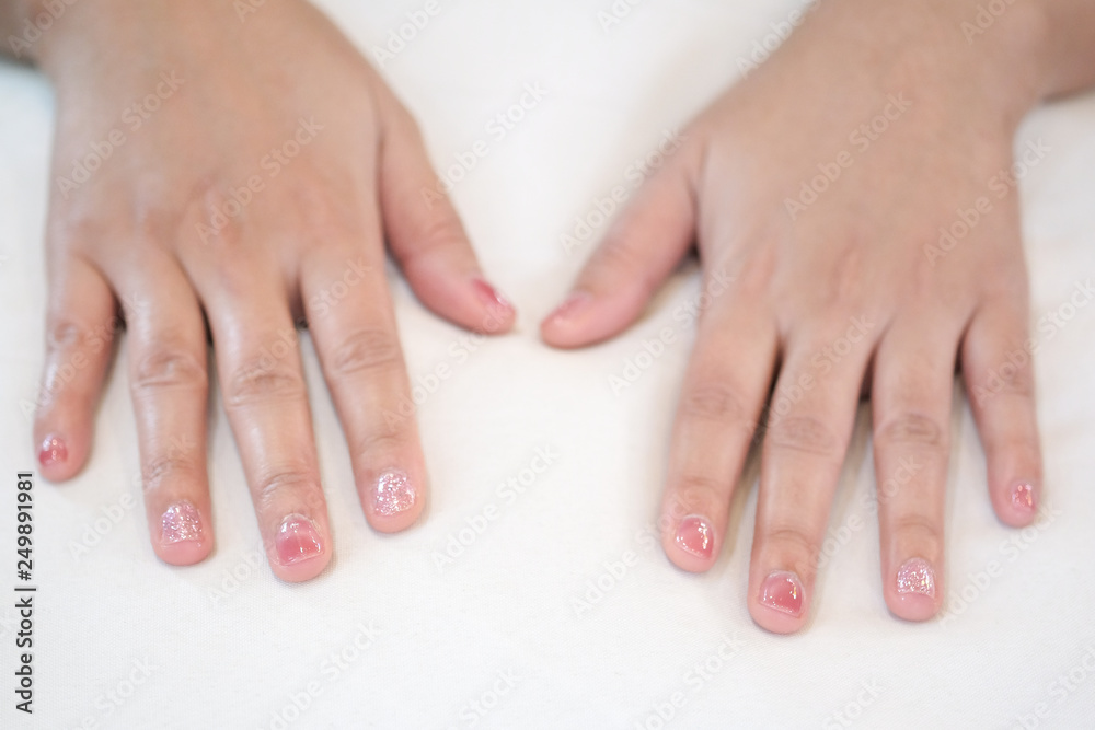 Hands placed on a white pillow