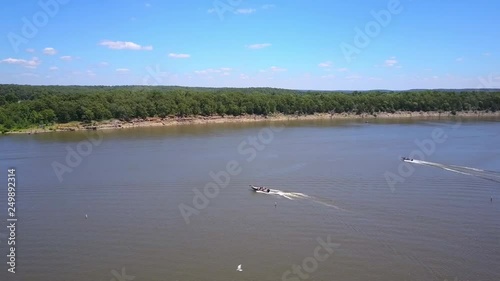 Fishing boats speeding out to make the first catch of the day on the lake.