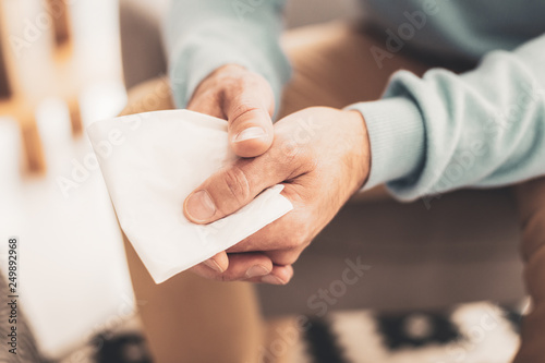 Depressed man holding napkin in hands