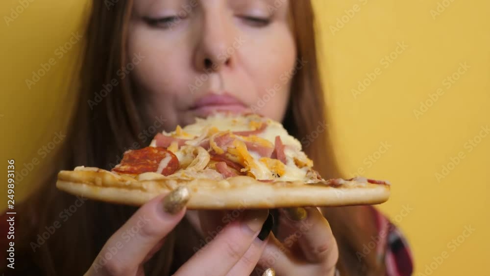 Piece Pizza . happy girl eating a slice of pizza concept . woman hungry eats a slice of pizza. slow motion video. pizza fast food concept lifestyle Piece Pizza . happy girl eating a slice of pizza concept . woman hungry eats a slice of pizza. slow motion video. pizza fast food concept lifestyle