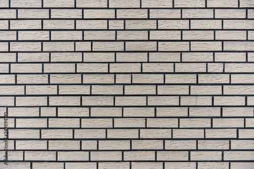 The brick exterior wall of the building is white brick.