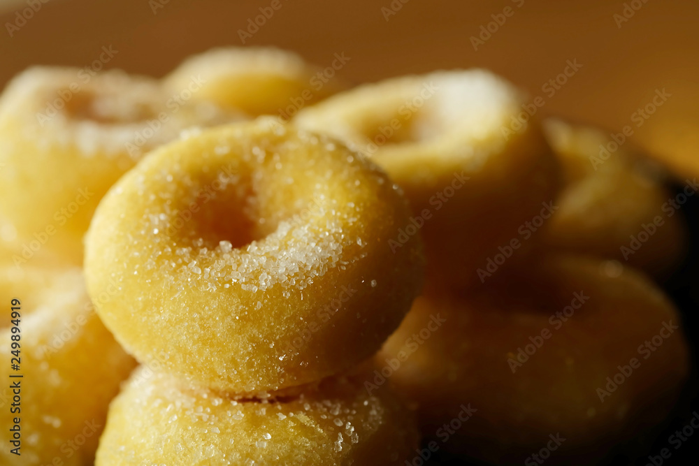 Fried donut with sugar, popular sweet  sold in market or restaurant, high calories, sugar and cholesterol level cause of many chronic disease such as diabetes and heart disease affect economic problem