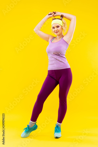 Appealing young woman in a good shape wearing sport clothes