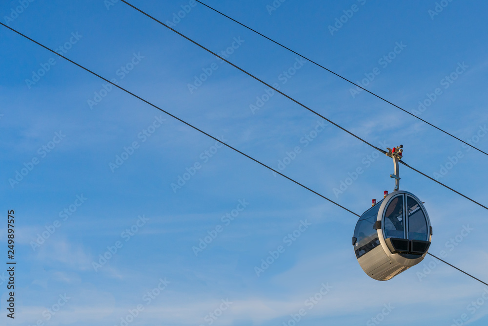 View of cableway gondola cable car on blue sky background View of cableway gondola cable car on blue sky background