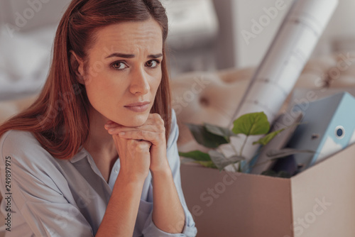 Obraz na plátně Worried young woman propping her chin with hands