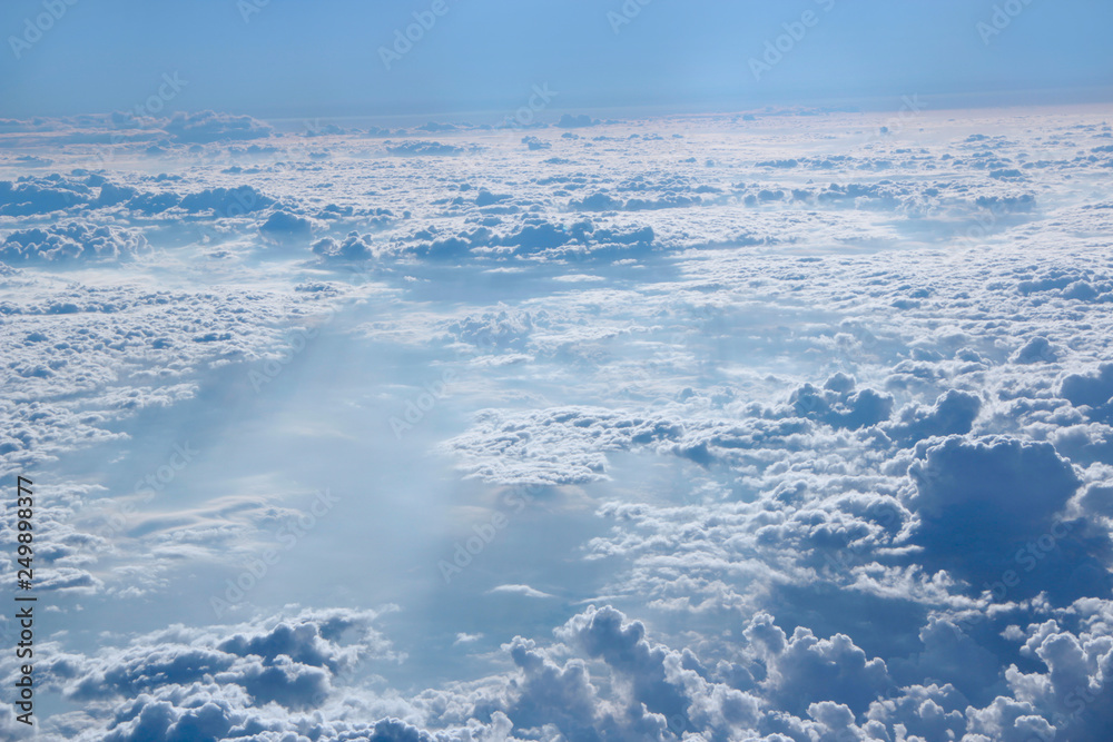 Panorama from window of plane with white clouds
