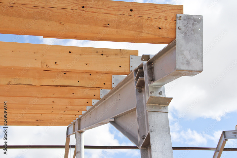 Wooden beams on a metal frame. Construction of agricultural buildings. The construction of the barn. Agriculture.