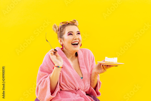 Positive woman loving sweets feeling excited before eating cake