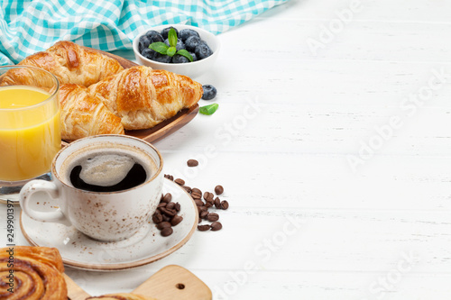 Coffee, juice and croissants breakfast