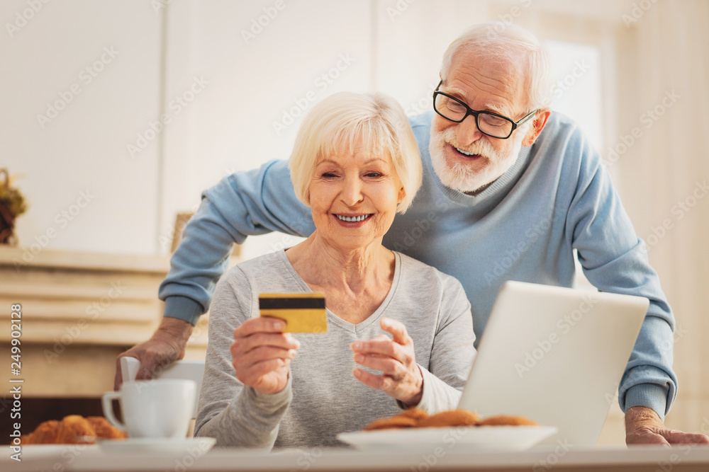 Caring man coming to his wife during tasty breakfast Caring man coming to his wife during tasty breakfast