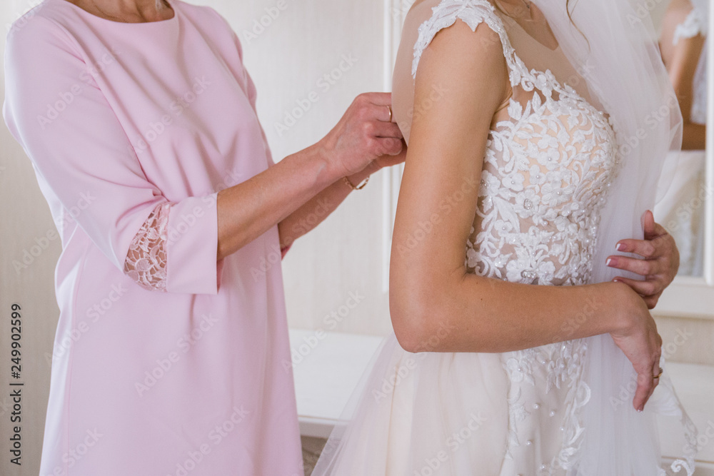 bride put on a wedding dress in the room bride put on a wedding dress in the room